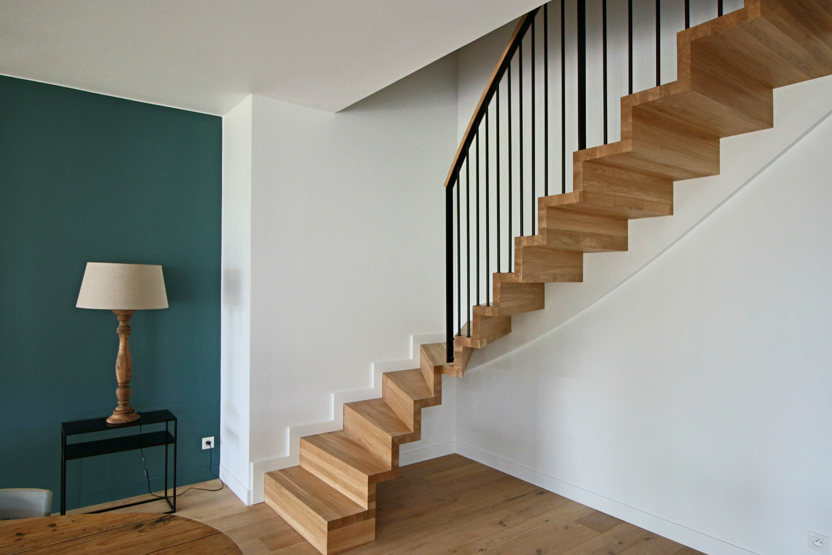 Escalier tournant en bois avec contremarches rampe à balustres métalliques en noir